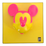 Close-up of a pink Mickey Mouse head silhouette on a yellow background, as on product packaging.