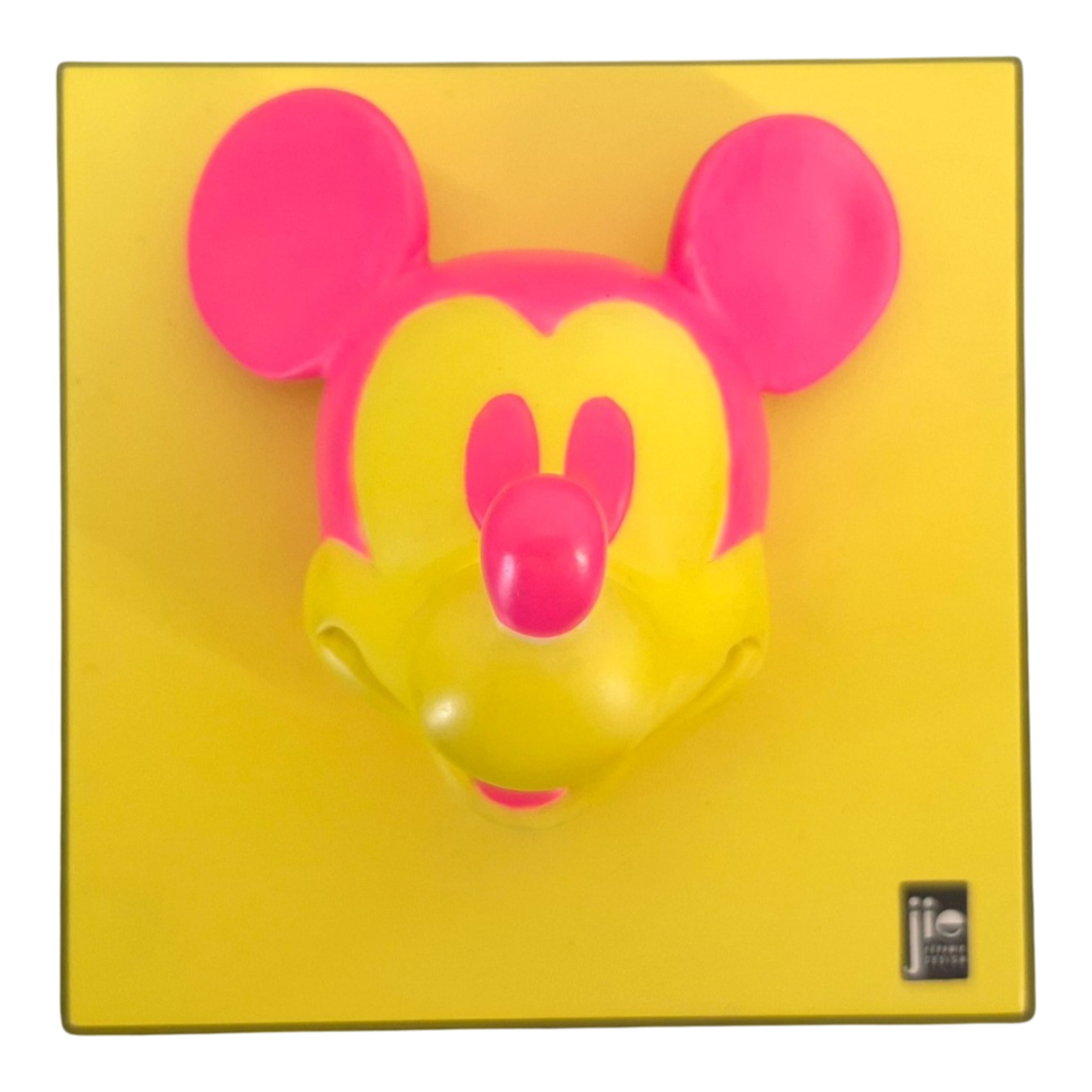 Close-up of a pink Mickey Mouse head silhouette on a yellow background, as on product packaging.