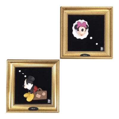 Gold-framed Disney display with black panels showing Minnie and Mickey figurines against a black background.